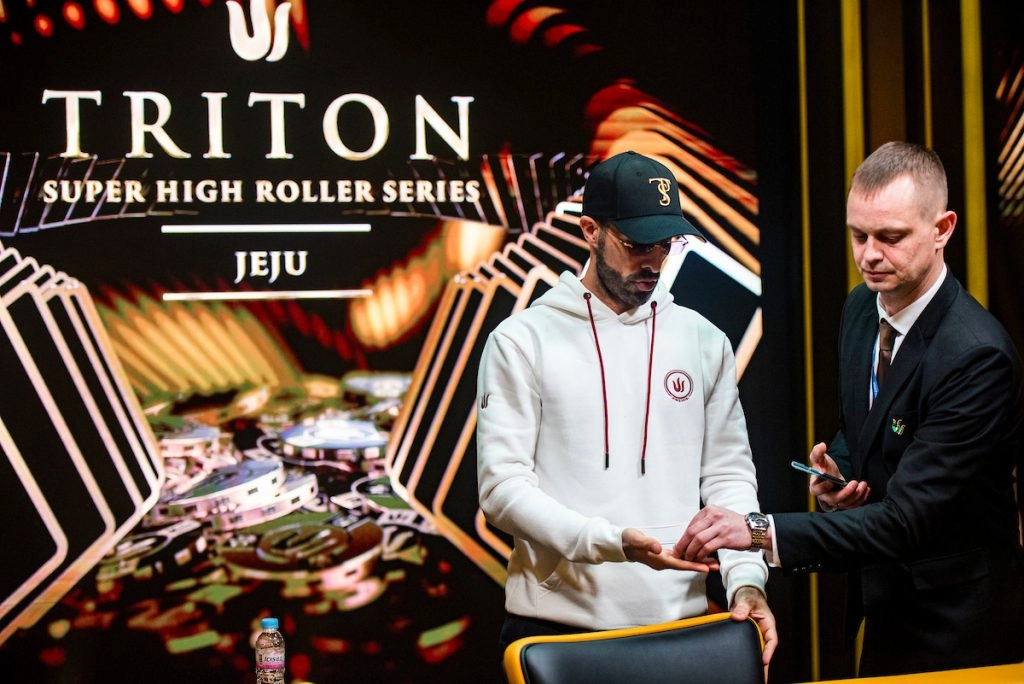 Sirzat Hissou takes his bounty chips as he’s sent to the cash desk